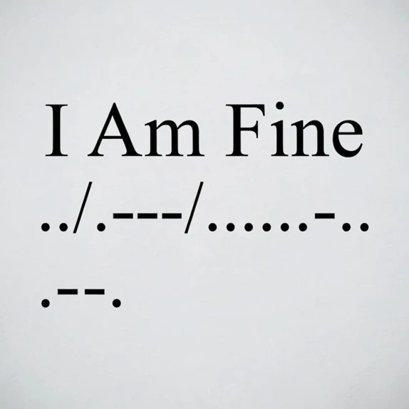 A white card displaying the Morse code for 'How Are You?' on top, followed by the phrase 'How Are You?' in bold text, with additional Morse code characters shown below, placed on a gray surface.